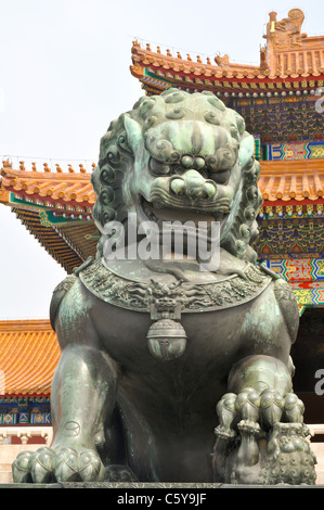 a bronze lion statue guarding the entrance to the imperial palace in beijing's forbidden city Stock Photo