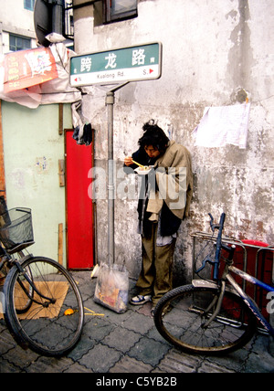 Shanghai, China. 30th Oct, 2006. A homeless man, with his