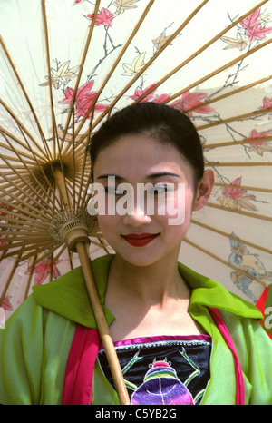 beautiful women poses for camera under chinese umbrella Stock Photo