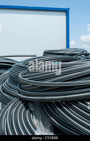 Coiled black PVC hoses. Polyethylene tubing Stock Photo