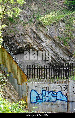 Graffiti on metal railings protecting old limestone mine works and fossil beds at Wren's Nest National Nature Reserve in Dudley Stock Photo