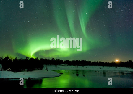 Northern Lights, also known as Aurora Borealis at moonset near Inari. Lapland, Finland.