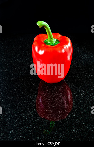 A perfect red bell pepper reflected in granite Stock Photo