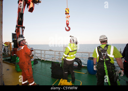 Construction workers on a jack up barge constructing the Walney offshore wind farm. Stock Photo