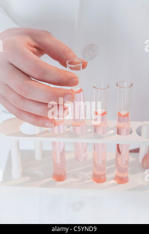 USA, Illinois, Metamora, close up of woman's hand holding laboratory vials Stock Photo
