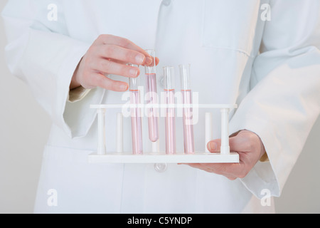 USA, Illinois, Metamora, close up of woman holding laboratory vials Stock Photo