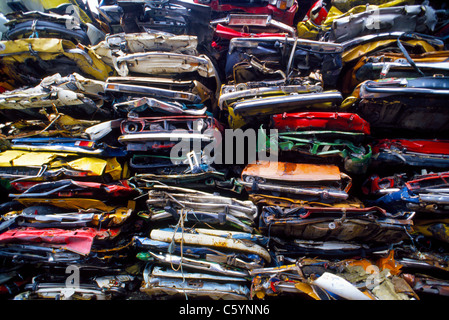 Old cars that have been mechanically crushed into scrap metal are stacked atop one another for recycling in Norway. Stock Photo