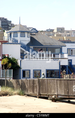 A building with the American Flag reflecting in the window near the Hyde Street Pier in San Francisco's Fisherman's Wharf Stock Photo