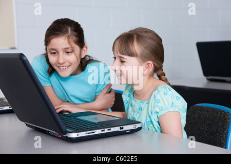 USA, Illinois, Metamora, Two girls looking at laptop (8-9, 10-11) in computer lab Stock Photo