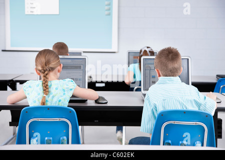 USA, Illinois, Metamora, Rear view of children (8-9, 10-11) using laptops in computer lab Stock Photo
