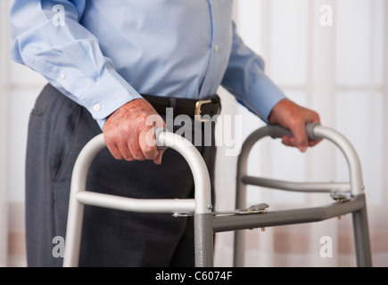 USA, Illinois, Metamora, Senior man walking with walker, mid section Stock Photo