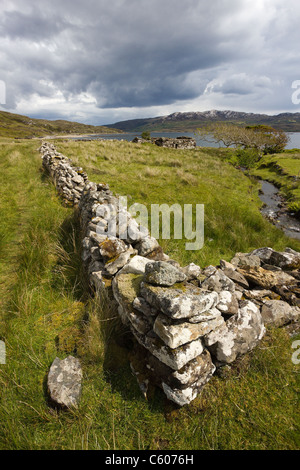 Ruined croft walls and crofts with Loch Eishort and Sleat Peninsula beyond. Boreraig, Isle of Skye, Scotland, UK Stock Photo