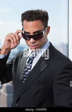 USA, New York State, New York City, portrait of business man wearing sunglasses Stock Photo