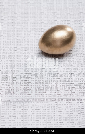 USA, Illinois, Metamora, Golden egg on newspaper stock quotes Stock Photo