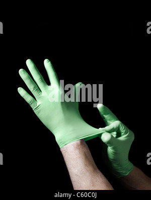 Hands putting on Surgical gloves Stock Photo