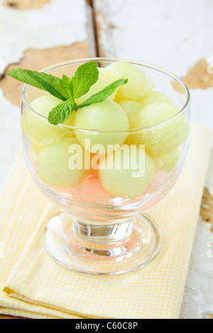 Fruit salad with melon and watermelon balls in glass bowl Stock Photo