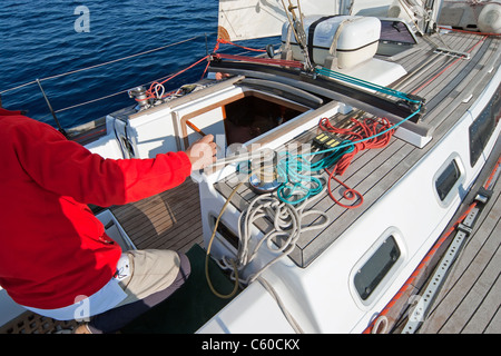 Sailor's hand on a winch of sailing boat in the sea Stock Photo