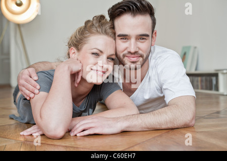 Couple embracing on floor Stock Photo