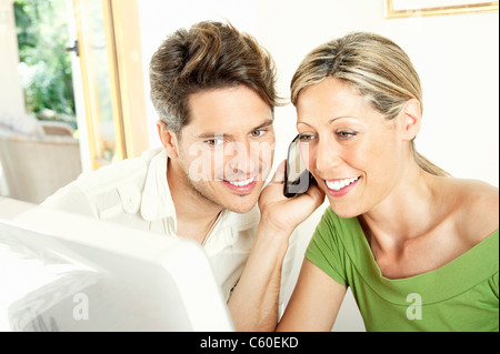 Couple talking on cell phone together Stock Photo
