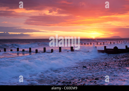 Sunset on Barmouth beach and the distant Llŷn Peninsula , North Wales, UK Stock Photo