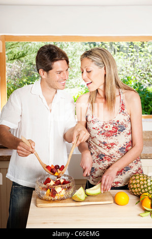 Couple cooking together in kitchen Stock Photo