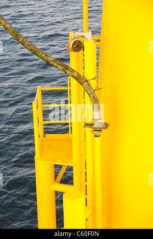 A pipe carries specialist grout to cement a transition piece to a monopile, on the Walney offshore wind farm. Stock Photo