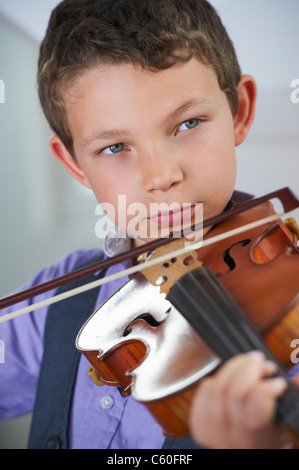 Serious boy playing violin Stock Photo