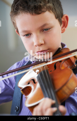 Serious boy playing violin Stock Photo