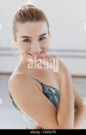 Smiling ballet dancer touching her chin Stock Photo