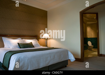 King size bed and luxury bathroom of a five star hotel suite room  Stock Photo