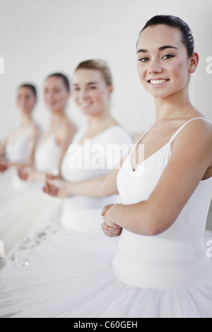 Ballet dancers holding hands in studio Stock Photo