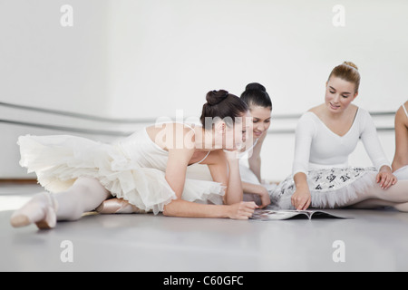 Ballet dancers reading magazine together Stock Photo
