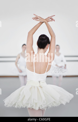 rear view of three young ballet dancers peeking through curtain Stock ...