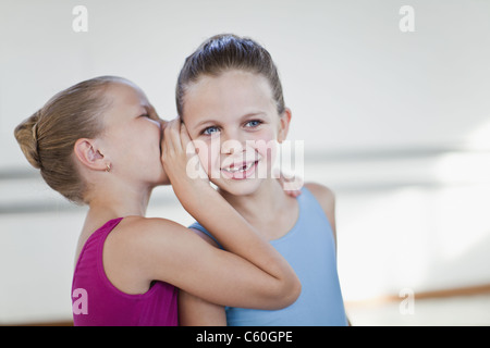 Ballet dancers whispering in studio Stock Photo