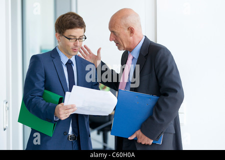 Businessmen talking in office Stock Photo