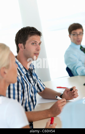 Businessman making notes in conference Stock Photo