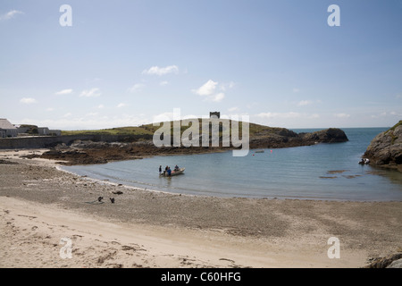 Rhoscolyn Anglesey North Wales UK Group men preparing motor boat to take lobster pots to sea Stock Photo