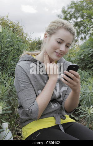 Runner checking her pulse in park Stock Photo