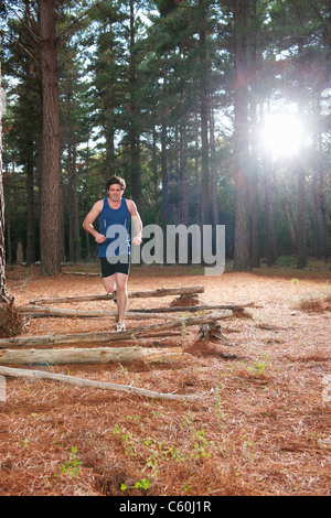 Man running in forest Stock Photo