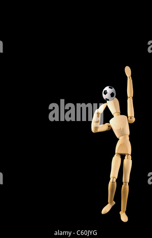 Mannequin with football isolated on black Stock Photo