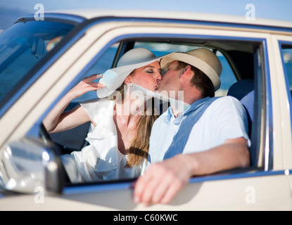 Newlywed couple kissing in car Stock Photo