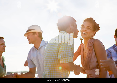 Couples talking on beach Stock Photo