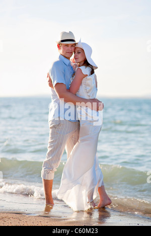 Newlywed couple embracing on beach Stock Photo