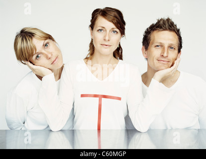 Woman holding friends faces Stock Photo