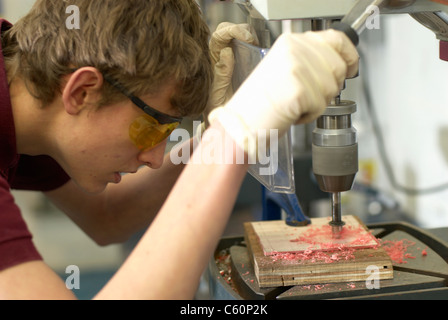 Worker using drill in factory Stock Photo
