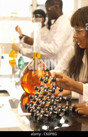 Scientist examining beaker in lab