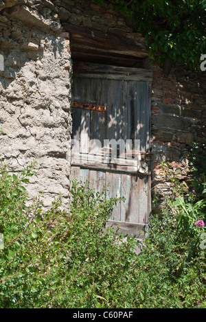 Very old weathered and dilapidated door in Vernazza, Cinque Terre, Italy. Stock Photo