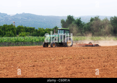 Tractor cultivating field Stock Photo