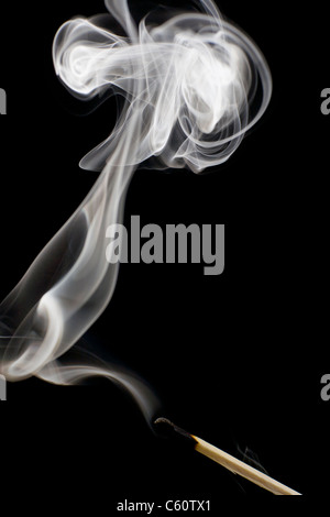 Smoke rises from a just extinguished match Stock Photo