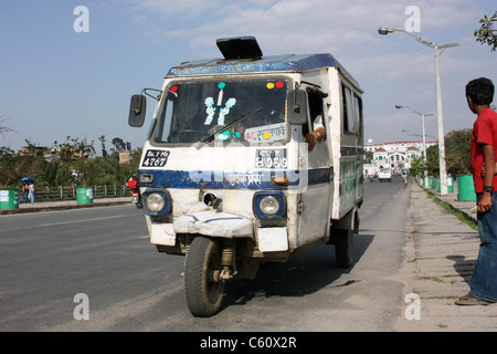 Three wheeler taxi bus stops for passenger city streets in Kathmandu Nepal Stock Photo